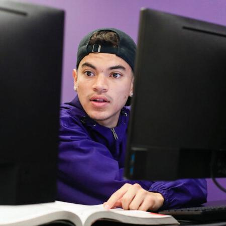 Student with book and computer